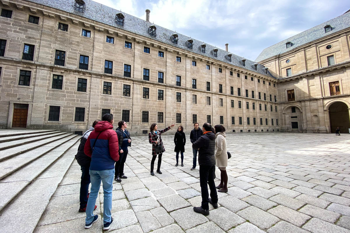 a group tour in El Escorial courtyard